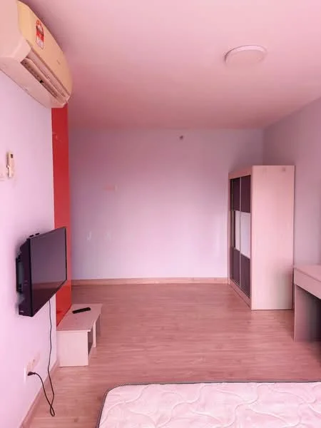 Room features: light purple painted walls, laminate flooring, wall-mounted air conditioning unit, mounted flat-screen TV, TV console, wooden wardrobe with sliding doors, study desk, mattress on the floor; style: minimalist.
