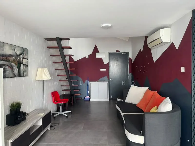 Living features: grey fabric sofa with orange and white cushions, wooden staircase leading to upper level, white painted walls with red and maroon accent wall, grey tile flooring, wall-mounted air conditioning unit, floor lamp, TV console, red office chair, decorative artwork on wall, built-in cabinet; style: modern.