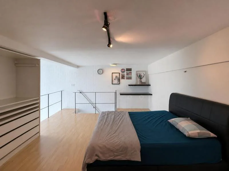 Bedroom features: queen-size bed with black upholstered headboard, light blue bedspread, wooden flooring, white painted walls, built-in wardrobe with sliding doors, desk with shelf above, wall-mounted clock, decorative wall art, track lighting, open space with railing; style: modern.