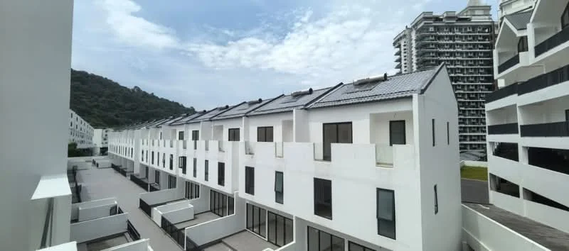 Exterior type: linked terrace house; features: white painted facade, flat roof, solar panels on roof, multiple storeys, balconies with glass railings, manicured walkway, surrounded by greenery, urban context with nearby high-rise buildings; style: modern.