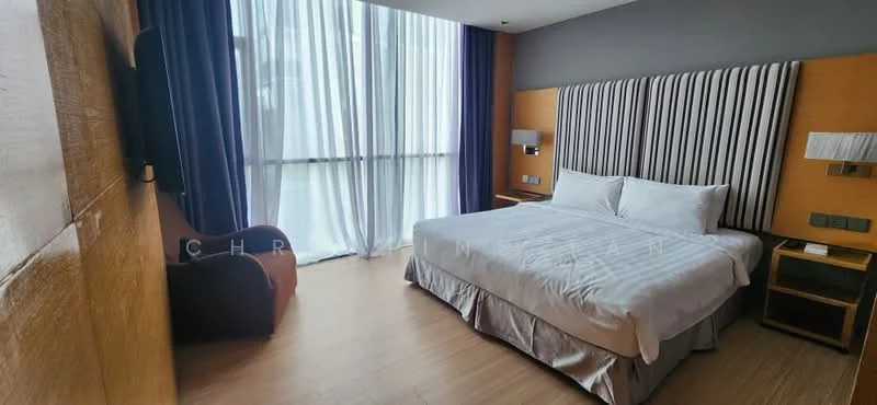 Bedroom features: king-size bed with white bedding, upholstered headboard with vertical stripes, wooden bedside table, wall-mounted reading lights, large floor-to-ceiling windows with sheer curtains, dark blue curtains, wooden flooring, armchair in dark fabric, decorative wall paneling, wall-mounted electrical outlets; style: modern.