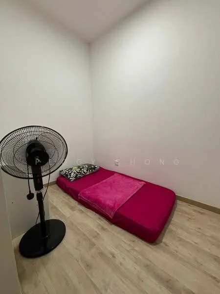 Bedroom features: single mattress on pink bed frame, pink blanket, black and white patterned pillow, floor fan, light wood laminate flooring, white painted walls, corner room with sloped ceiling.