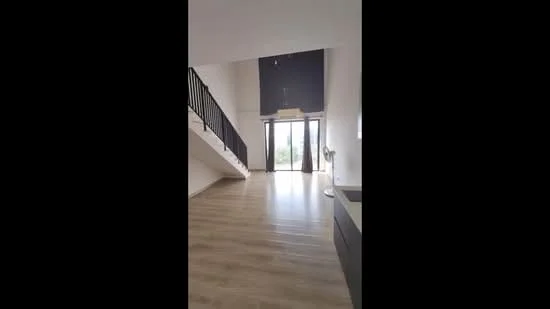 Living features: wooden flooring, high ceiling, floor-to-ceiling windows, sliding glass door, black railing, neutral painted walls, ceiling lights, fan, open layout, natural light, view of greenery; style: modern; view: garden.
