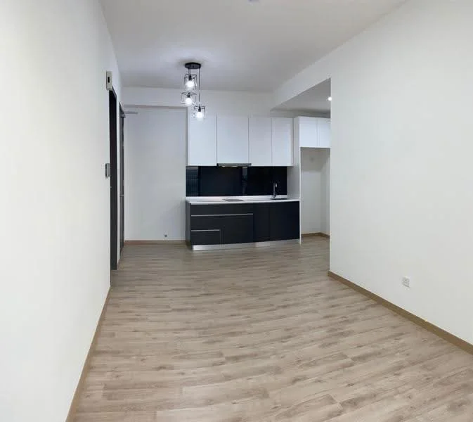 Living features: light wood laminate flooring, white painted walls, recessed downlights, pendant light fixture, open-plan layout, kitchen area with black cabinetry, white upper cabinets, black countertop, built-in kitchen appliances, no visible window treatments; style: modern.