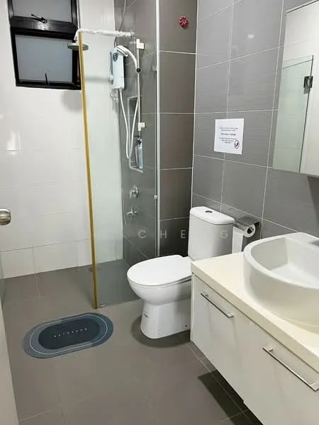Bathroom features: white ceramic toilet, walk-in shower with glass enclosure, chrome shower head, single-bowl sink, white countertop, white cabinetry with drawers, grey tiled walls, grey floor tiles, mirror above sink, window for natural light; style: modern.