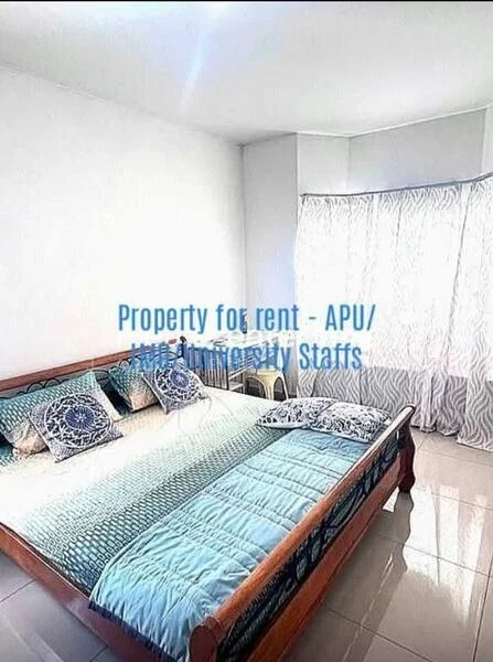 Bedroom features: king-size bed, wooden bed frame, blue and white bedding, two decorative pillows, white painted walls, large window with sheer curtains, glossy tile flooring, natural light from window.
