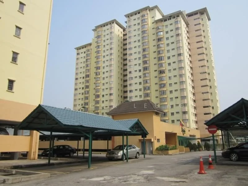 Exterior type: high-rise condominium; features: yellow painted facade, multi-storey building, covered car parking, open-air parking lot, landscaped area, security gate, surrounded by mature greenery; style: modern.
