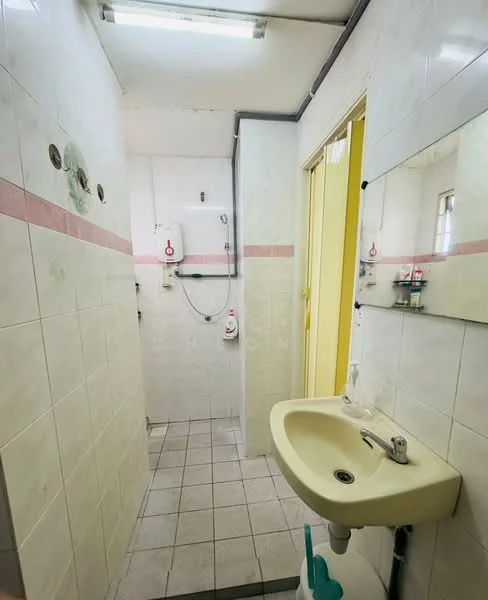 Bathroom features: white tiled walls, light grey tiled flooring, single-bowl sink, chrome faucet, mirror above sink, shower area with wall-mounted showerhead, toilet, pink accent stripe on wall, ceiling light fixture.