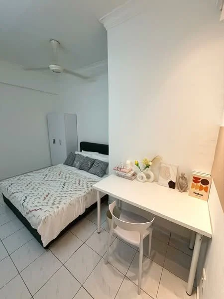 Bedroom features: queen-size bed with white bedding, two decorative pillows, white painted walls, ceiling fan, white tiled flooring, study desk with white surface, transparent plastic chair, decorative items on desk, built-in wardrobe, natural light from window; style: modern.
