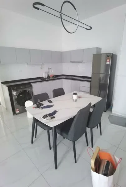 Kitchen features: grey cabinetry, black granite countertop, stainless-steel fridge, built-in washing machine, 4-seater dining table, grey upholstered dining chairs, pendant light fixture, white tiled flooring, single-bowl stainless-steel sink, chrome pull-down faucet; style: modern.