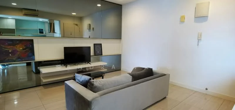 Living features: grey fabric sofa, flat-screen TV on wall-mounted console, white wall with mirror panel, light-colored tiled flooring, recessed lighting, air conditioning unit, decorative artwork on wall, neutral color scheme; style: modern.