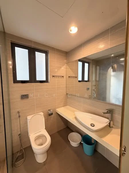 Bathroom features: white ceramic toilet, single-sink vanity with wall-mounted basin, mirror above vanity, grey tile flooring, light beige wall tiles, shower area with glass enclosure, chrome showerhead, two windows for natural light, built-in shelving, blue waste bin; style: modern.