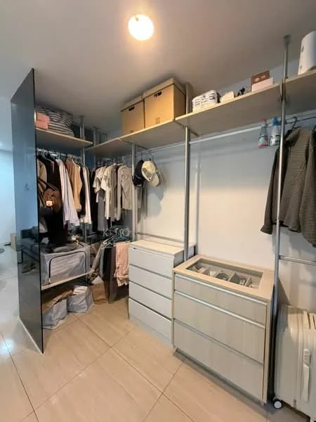 Room features: built-in shelving, hanging rods for clothes, drawers, storage boxes, neutral wall color, tile flooring, overhead lighting; style: modern.