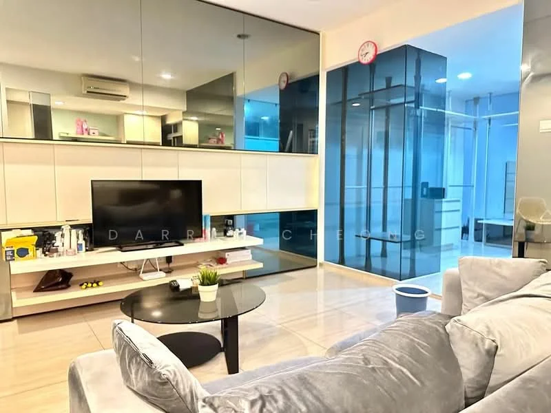 Living features: grey fabric sofa, round black coffee table, wall-mounted TV, white cabinetry, glass wall partition, mirrored wall, recessed lighting, air conditioning unit, light-colored tile flooring, decorative clock on wall, potted plant on table; style: modern.