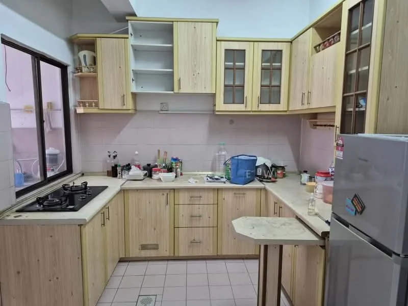 Kitchen features: light wood cabinetry, laminate countertop, double-bowl stainless-steel sink, 4-burner gas hob, built-in refrigerator, wall-mounted cabinets with glass doors, tile backsplash, window above sink, floor tiles, kitchen island with table extension, various kitchen appliances and utensils visible; style: modern.