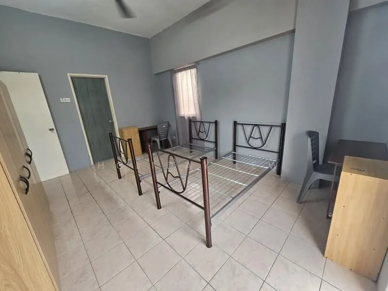 Bedroom features: grey painted walls, tile flooring, single metal bed frame, wooden wardrobe, study desk, plastic chair, window with sheer curtains, ceiling fan; style: minimalist.