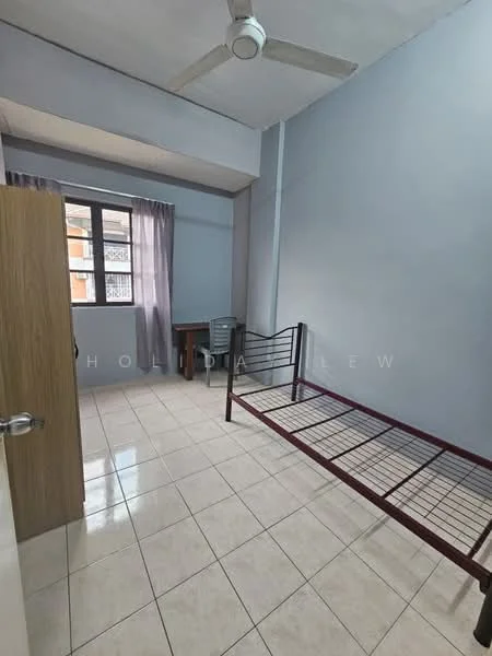 Bedroom features: light blue painted walls, white tiled flooring, single metal bed frame, ceiling fan, window with sheer curtains, wooden door, study desk, chair.