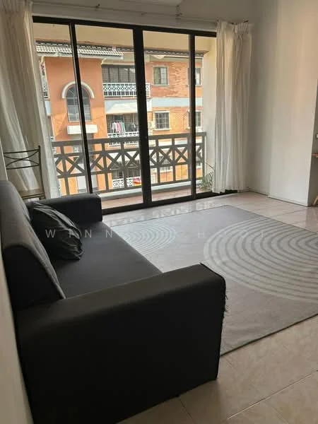 Living features: black fabric sofa, area rug with circular pattern, floor-to-ceiling windows, sheer curtains, balcony with railing, tile flooring, white painted walls, natural light from windows; style: modern; view: courtyard.