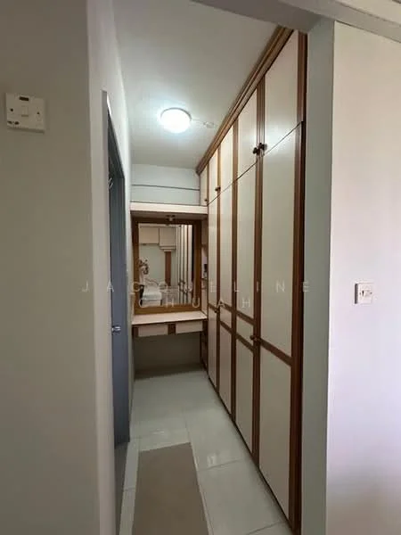 Room features: built-in wardrobe with wooden doors, mirror on wall, light fixture on ceiling, white tiled flooring, neutral wall color, vanity table with drawer, narrow hallway layout; style: modern.