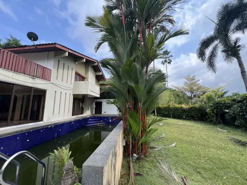 Exterior type: detached bungalow; features: swimming pool, manicured lawn, tropical landscaping, palm trees, red painted facade, sloping tiled roof, balcony with railing, large windows, outdoor lighting, stone-paved walkway; style: modern.