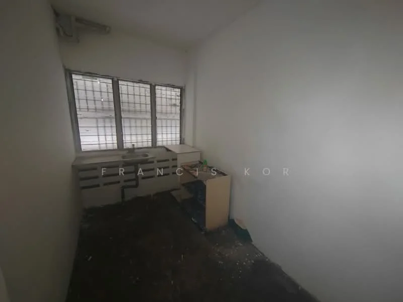 Room features: white painted walls, concrete flooring, two windows with metal grilles, built-in cabinets, small countertop, wooden cabinet, unknown appliances.