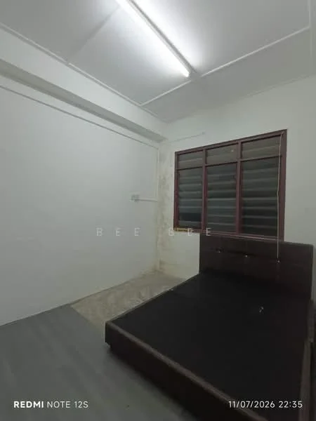 Bedroom features: white painted walls, grey laminate flooring, single bed, window with metal grilles, ceiling light fixture, built-in wardrobe, plain ceiling, no visible decor; style: minimalist.