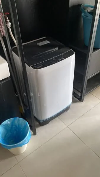 Laundry features: top-load washing machine in white, black cabinetry, grey tiled flooring, plastic laundry basket in blue, white plastic trash bin, sink with faucet.
