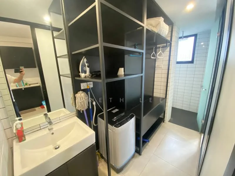 Laundry features: white sink with cabinet, black shelving unit, built-in wardrobe, washing machine, tile flooring, white tiled walls, mirror above sink, hanging space for clothes, window for natural light; style: modern.
