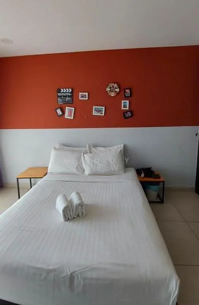 Bedroom features: queen-size bed, white bed linens, orange accent wall, white painted walls, tile flooring, nightstand, decorative wall art, towels neatly arranged; style: modern.