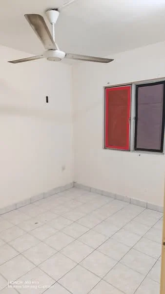 Room features: white painted walls, tile flooring, ceiling fan, single window with red and black treatments, light switch on wall, corner wall with no visible features.