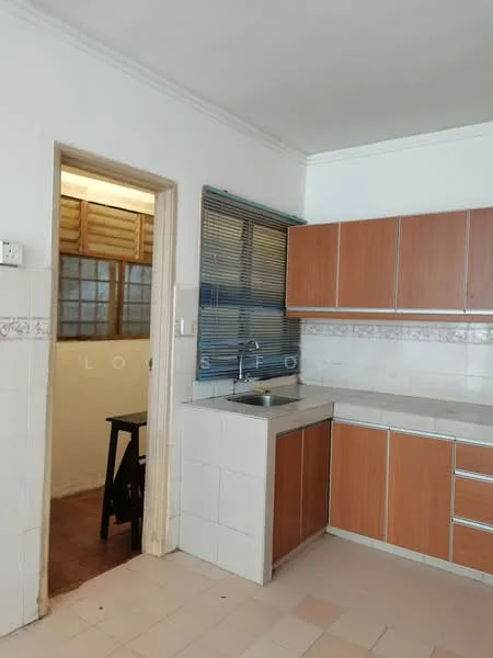 Kitchen features: brown wooden cabinetry, white tiled backsplash, stainless-steel sink, chrome faucet, countertop with white surface, wall-mounted window with blinds, tile flooring, doorway leading to another room.