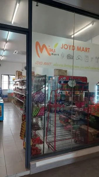Exterior type: retail shop; features: glass facade, signage with logo, shelves stocked with products, display racks, tile flooring, bright overhead lighting, entrance door, window display; style: modern.