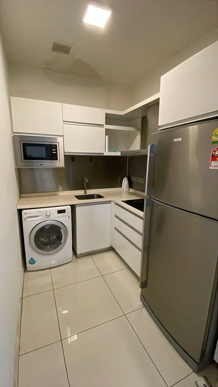 Kitchen features: white cabinetry, stainless-steel fridge, built-in microwave, single-bowl stainless-steel sink, chrome pull-down faucet, white countertop, washing machine, ceramic tile flooring, recessed downlights; style: modern.