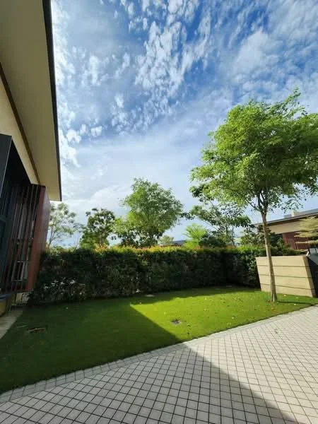 Exterior features: manicured lawn, mature trees, paved walkway, hedge boundary, clear blue sky, clouds, greenery, outdoor space; style: modern.