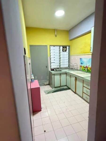 Kitchen features: yellow painted walls, white cabinetry with gold handles, green countertop, single-bowl stainless-steel sink, chrome faucet, tile flooring, window with horizontal slats, built-in shelves, pink cabinet, light fixture in ceiling.