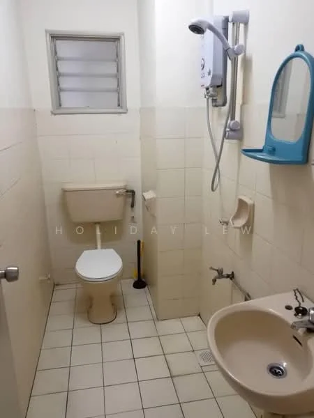 Bathroom features: white tiled walls, cream tiled flooring, one-piece toilet, sink with pedestal, chrome basin mixer faucet, shower with wall-mounted showerhead, mirror with blue frame, grab bar, window for natural light, toilet paper holder, shower curtain rod.