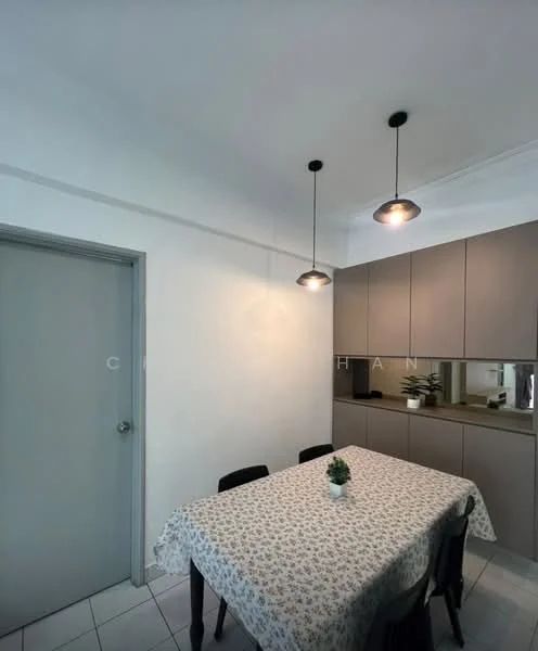 Dining features: white walls, tile flooring, rectangular dining table with floral tablecloth, four black dining chairs, built-in cabinetry with grey finish, two pendant lights, mirror backsplash, small potted plant on table; style: modern.