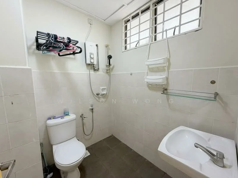 Bathroom features: white tiled walls, grey tiled flooring, one-piece toilet, chrome basin mixer faucet, white sink, shower head, wall-mounted shower mixer, wall-mounted storage rack, window with metal grille.