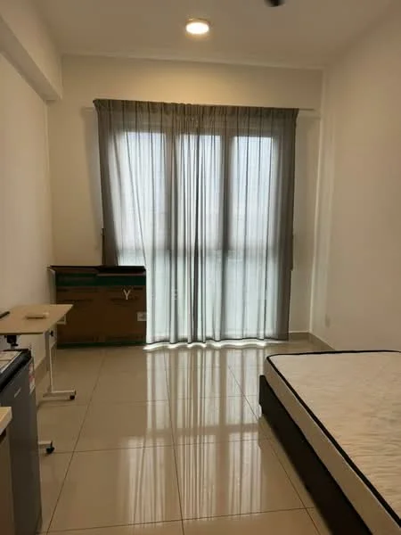 Bedroom features: large window with sheer curtains, white walls, tile flooring, single bed frame, mattress, small side table, fridge, cardboard box, ceiling light.