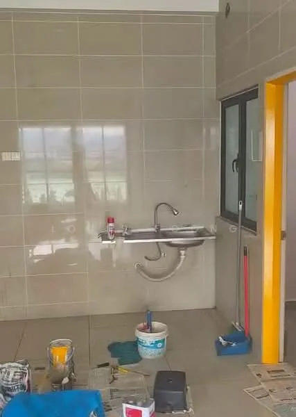 Room features: grey tiled walls, light grey tiled flooring, single-bowl stainless-steel sink, chrome faucet, window with black frame, yellow door frame, paint cans, cleaning tools, bucket, mop, sweeping broom.