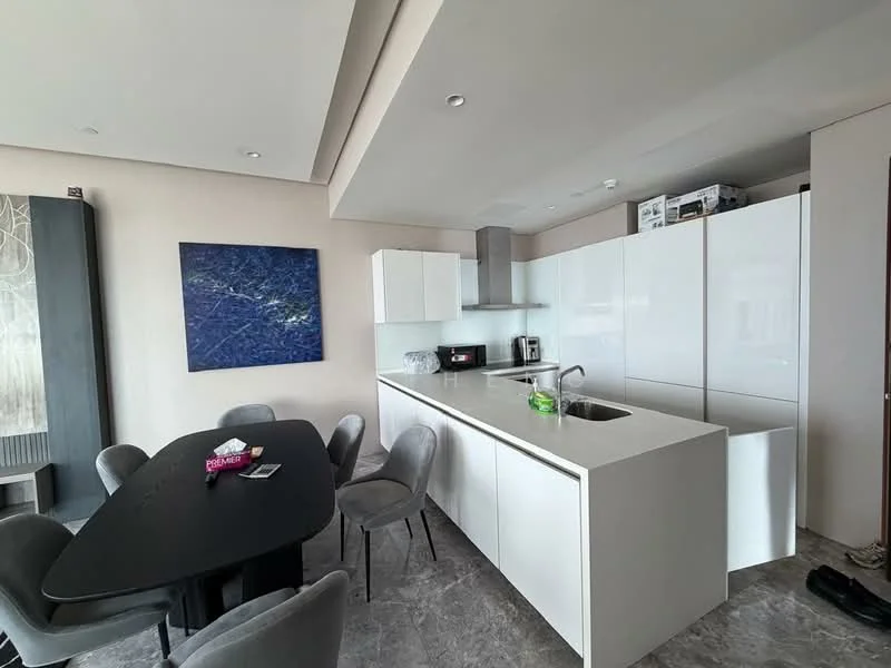 Kitchen features: white cabinetry, marble countertop, single-bowl stainless-steel sink, chrome pull-down faucet, built-in oven, freestanding microwave, 4-burner gas hob, grey upholstered dining chairs, black dining table, recessed downlights, grey marble flooring, open layout; style: modern.