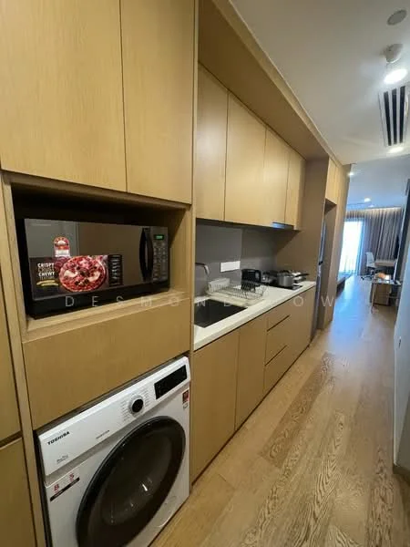 Kitchen features: light wood cabinetry, white countertop, built-in microwave, stainless-steel sink, single-bowl stainless-steel sink, built-in oven, front-load washing machine, wooden flooring, recessed downlights, wall-mounted cabinets, countertop space, kitchen utensils visible; style: modern.