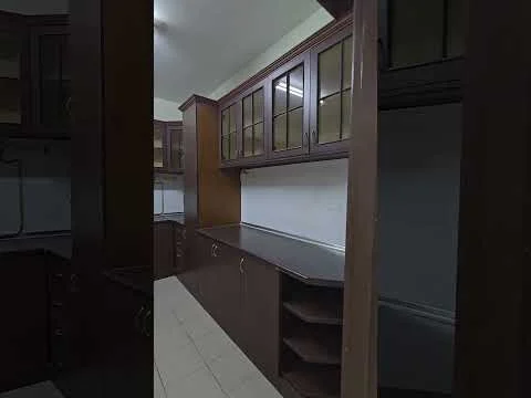 Kitchen features: dark wood cabinetry with glass-front upper cabinets, laminate countertop, tile flooring, built-in shelving, white walls, under-cabinet lighting, single-bowl stainless-steel sink, stainless-steel faucet, wall-mounted electrical outlets, crown moulding, open shelving; style: modern.