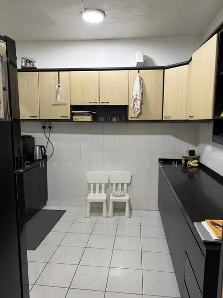 Kitchen features: black cabinetry, light wood upper cabinets, white tiled backsplash, white tiled flooring, recessed ceiling lights, double white plastic chairs, black countertop, kettle, dish rack, wall-mounted towel rack; style: modern.