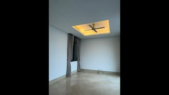 Room features: white painted walls, marble flooring, tray ceiling with integrated lighting, 5-blade ceiling fan, floor-to-ceiling window with sheer curtains; style: modern.