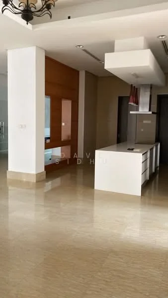 Kitchen features: island countertop, white cabinetry, stainless-steel range hood, built-in oven, marble flooring, recessed lighting, wood accent wall, open layout; style: modern.