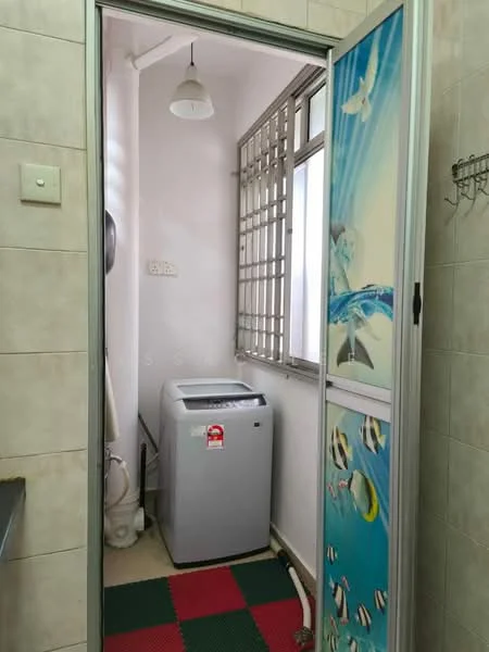 Laundry features: top-load washing machine, window with metal grille, light fixture, tile flooring, white painted walls, green and red rubber mat flooring, hanging hooks on wall.