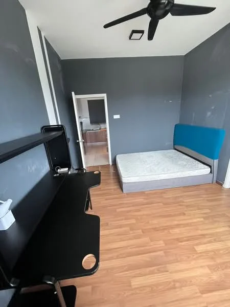 Bedroom features: grey painted walls, wooden flooring, 5-blade ceiling fan, single bed frame without mattress, study desk with black finish, doorway leading to another room, window with no visible treatment; style: modern.