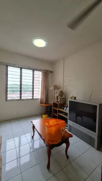 Living features: white painted walls, glossy ceramic tile flooring, ceiling light fixture, large windows with metal grilles, curtains, wooden coffee table, television, bookshelf, floor lamp, orange tote bag.