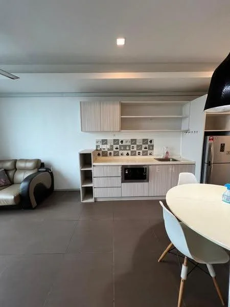 Kitchen features: white cabinetry, grey tiled backsplash, single-bowl stainless-steel sink, built-in oven, freestanding fridge, countertop with storage, open shelving, recessed ceiling lights, grey floor tiles, dining table with white chairs, sofa in beige and brown, ceiling fan; style: modern.